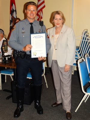 Daytona Beach Police Officer Cody Cassidy is congratulated by state Sen. Dorothy Hukill after receiving the Volusia Motor officer of the Year Award.