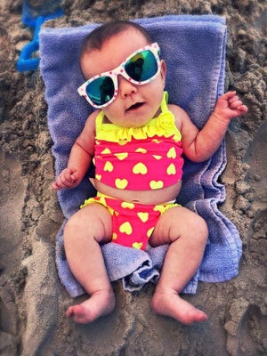 Kaitlynn Ivalee, 2 months, already knows she enjoys the beach. Photo submitted by her father, Cody Strawn.