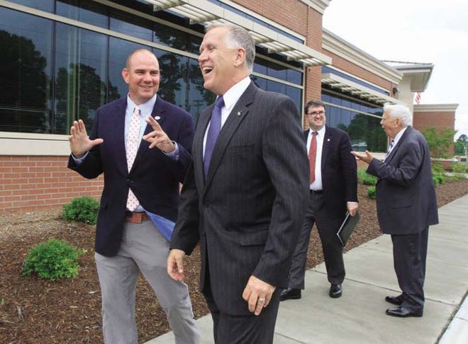 U.S. Senator Thom Tillis, front right, shares a laugh with Havelock Mayor Will Lewis Wednesday. Tillis spoke at Cherry Point.