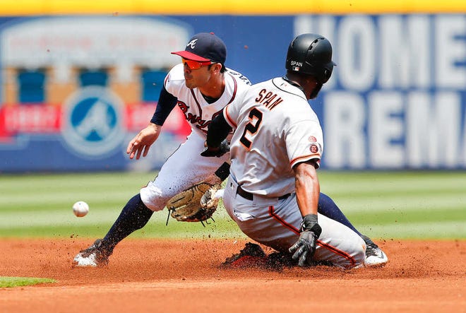 San Francisco's Denard Span steals second base as Atlanta third baseman Chase d'Arnaud handles the throw in the first inning. Atlanta starter Aaron Blair worked his way out of the jam.