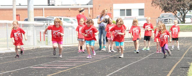 Camden-Frontier Elementary School students take part in the 50-yard dash Tuesday during field day at the school. COREY MURRAY PHOTO