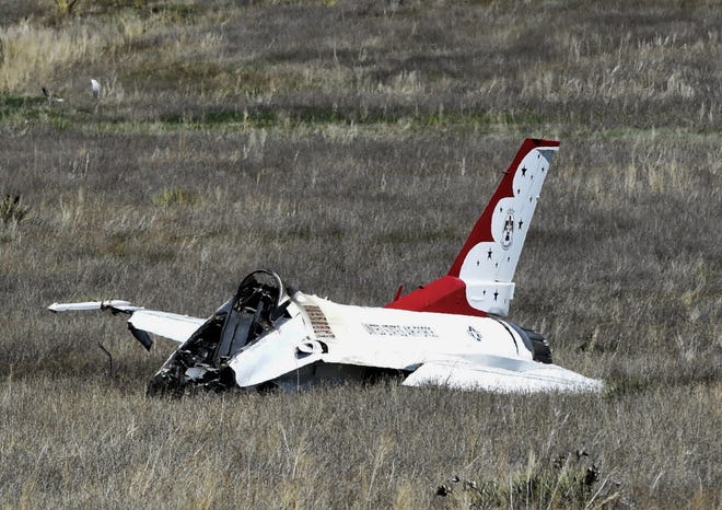 A U.S. Air Force Thunderbird that crashed following a flyover rests on the ground south of the Colorado Springs, Colo., airport after a performance at a commencement for Air Force Academy cadets Thursday. Jerilee Bennett/The Gazette via AP