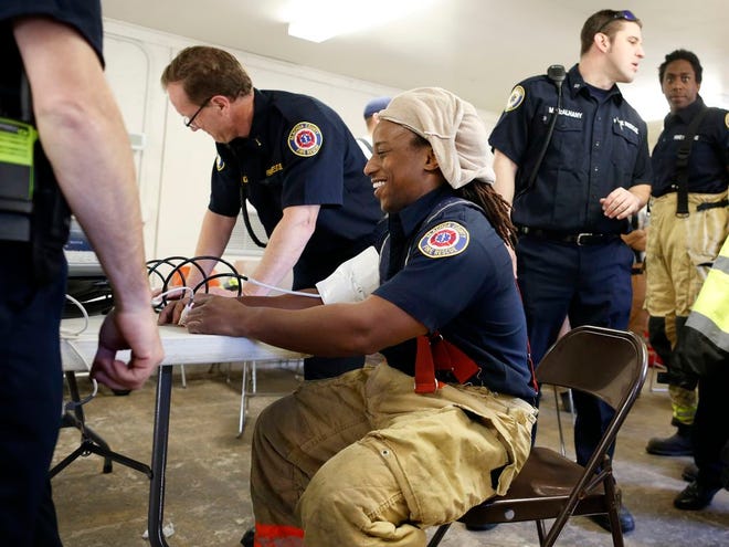 Alachua County Fire Rescue Firefighter/EMT Steffon Wilcox undergoes a vitals check before a training exercise at the Fire Training Center at Loften High School. A "Firefighter for a Day" event is set for Saturday at the school. Guardian file photo