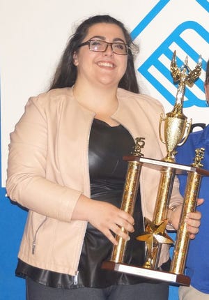 Hannah Raposo is shown holding the Boys & Girls Club Youth of the Year award.