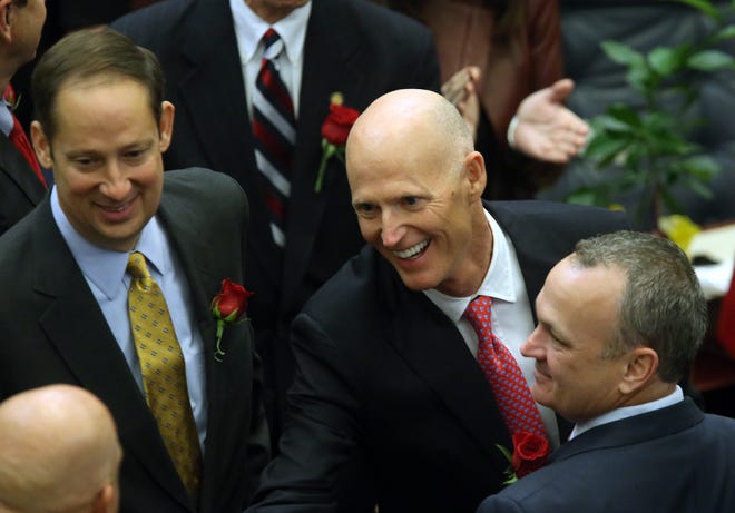 Florida Gov. Rick Scott, center, received approval to fill positions in three circuit courts stretching from northeast Florida to southwest Florida by the Florida Supreme Court on Friday.