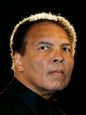 FILE - In this Dec. 17, 2005, file photo, boxing legend Muhammad Ali poses in Berlin, Germany. Ali, the magnificent heavyweight champion whose fast fists and irrepressible personality transcended sports and captivated the world, has died according to a statement released by his family Friday, June 3, 2016. He was 74. (AP Photo/Franka Bruns)