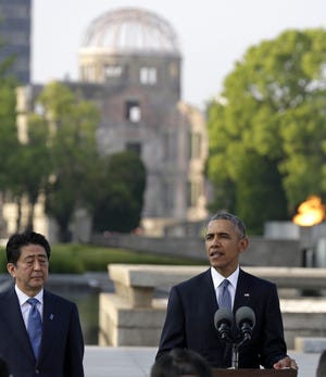 U.S. President Barack Obama delivers remarks, accompanied by Japanese Prime Minister Shinzo Abe at Hiroshima Peace Memorial Park in Hiroshima May 27. AP PHOTO BY CAROLYN KASTER