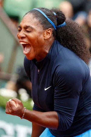 Serena Williams of the U.S. clenches her fist after scoring a point in the semifinal match of the French Open tennis tournament against Netherlands' Kiki Bertens at the Roland Garros stadium in Paris, France, Friday, June 3, 2016. (AP Photo/Alastair Grant)