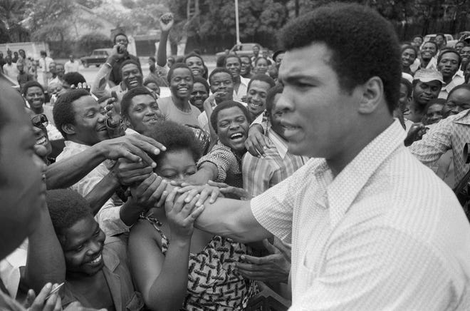 Muhammad Ali is greeted in downtown Kinshasa, Zaire on Sept. 17, 1974. He became a cultural icon for not only what he did in the boxing ring, but for his efforts to bring cultural and political change. Associated Press