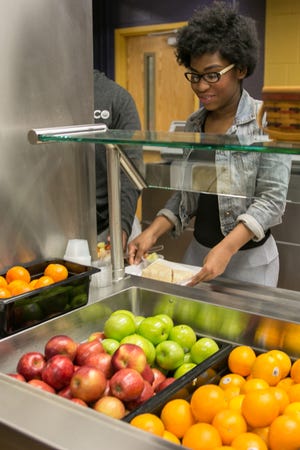 Monet Hall grabs some fruit in the cafeteria at Newburgh Free Academy. Newburgh schools require students to take a fruit or vegetable with their lunch. ALLYSE PULLIAM/For the Times Herald-Record
