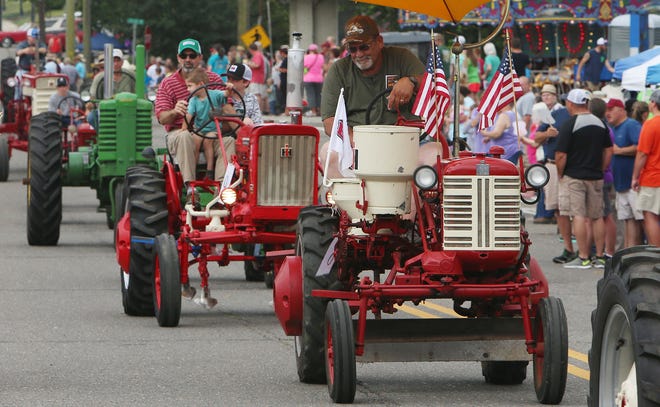 Participants in the tractor and antique car parade travel down Main Street during Gordo's Mule Day and Chickenfest in Gordo, Ala. on Saturday June 4, 2016.