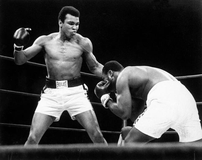 FILE - In this Jan. 28, 1974, file photo, Muhammad Ali throws a punch at Joe Frazier, right, in the twelfth round during their bout at Madison Square Garden in New York. Ali, the magnificent heavyweight champion whose fast fists and irrepressible personality transcended sports and captivated the world, has died according to a statement released by his family Friday, June 3, 2016. He was 74. (AP Photo/File)
