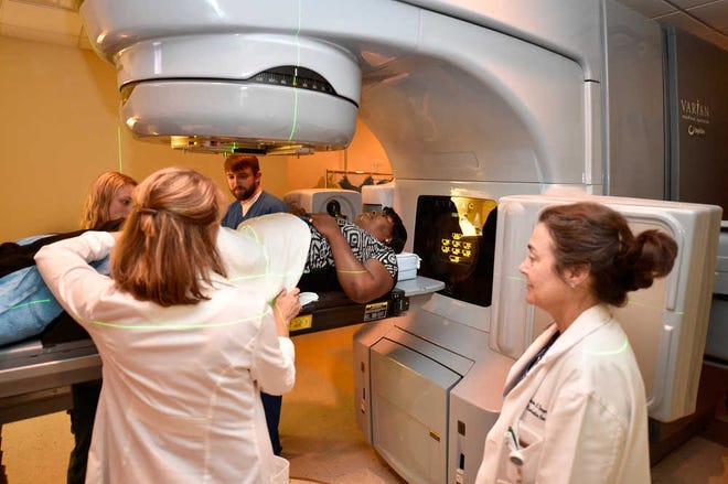 Valerie Ferguson is prepped for radiation therapy as Dr. Catherine Ferguson (right) watches at the Georgia Radiation Therapy Center in Augusta.