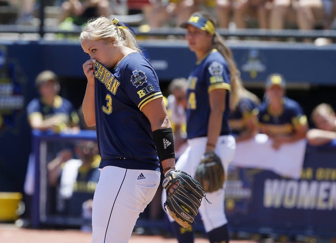 Michigan's Megan Betsa walks back to the mound after Florida State scored in the third inning of a softball game in the Women's College World Series in Oklahoma City, Sunday, June 5, 2016. (Bryan Terry/The Oklahoman via AP)