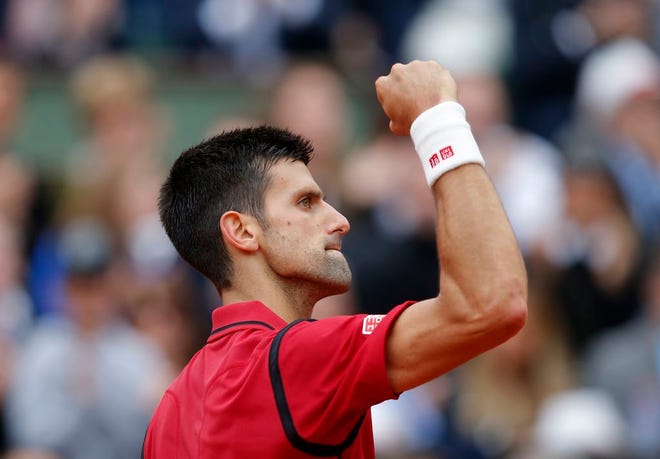 Serbia's Novak Djokovic clenches his fist after scoring a point in the final of the French Open tennis tournament against Britain's Andy Murray at the Roland Garros stadium in Paris, France, Sunday, June 5, 2016.