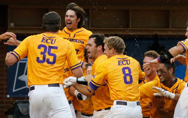 East Carolina catcher Travis Watkins, center, is mobbed by teammates after hitting the game-winning three-run home run against Virginia on Saturday.
