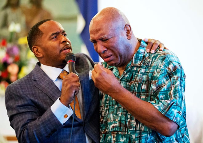 Rahaman Ali, brother of Muhammad Ali, right, cries while embraced by assistant pastor Rev. Charles Elliott, III., during a service at King Solomon Missionary Baptist Church where Muhammad Ali's father worshipped and where Muhammad Ali would occasionally accompany him, Sunday, June 5, 2016, in Louisville, Ky. Muhammad Ali, the magnificent heavyweight champion whose fast fists and irrepressible personality transcended sports and captivated the world, died Friday at the age of 74. (AP Photo/David Goldman)