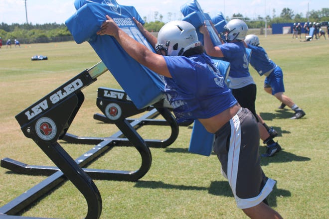 Matanzas linemen hit the Lev-Sled during Tuesday's workout as spring practice gets underway. NEWS-TRIBUNE/ANDY MIKULA
