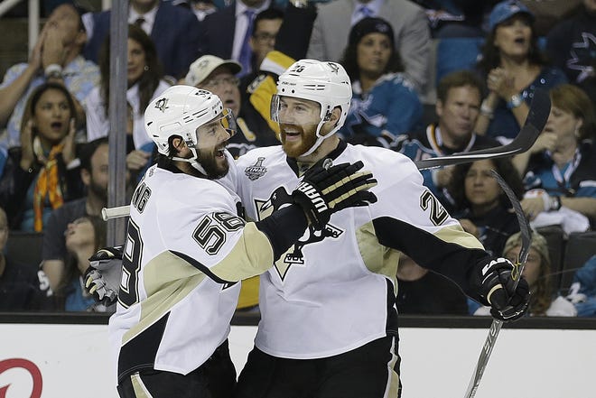 Pittsburgh's Ian Cole, right, celebrates with Kris Letang during Monday's Game 4 win over the Sharks in the Stanley Cup Finals. The Penguins won, 3-1, to take a 3-1 series lead. AP Photo