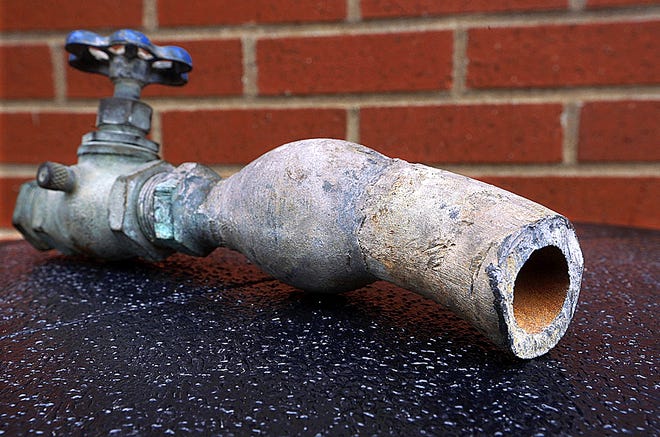 In this March 9 file photo, city officials display an example of lead water pipes in Galesburg. Federal regulators are recommending that the city of Galesburg provide bottled water or filters to residents affected by high levels of lead in the drinking water. The actions come in response to an investigation published this month by The Associated Press, which found that Galesburg had one of the nation's most persistent problems of lead in the drinking water.