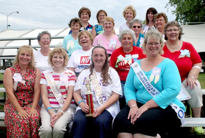 In this file photo from 2006, Jennifer Thornton, then the Michigan Homemaker of the Year, (first row, first on the right) sits for a photo with several other local residents who had won the Monroe County Homemaker title over the years. (Monroe News photo by RENEE DEEMER