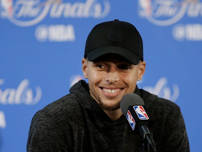 Golden State Warriors guard Stephen Curry smiles at a news conference after Game 2 of basketball's NBA Finals against the Cleveland Cavaliers in Oakland, Calif., Sunday, June 5, 2016. The Warriors won 110-77. (AP Photo/Ben Margot)