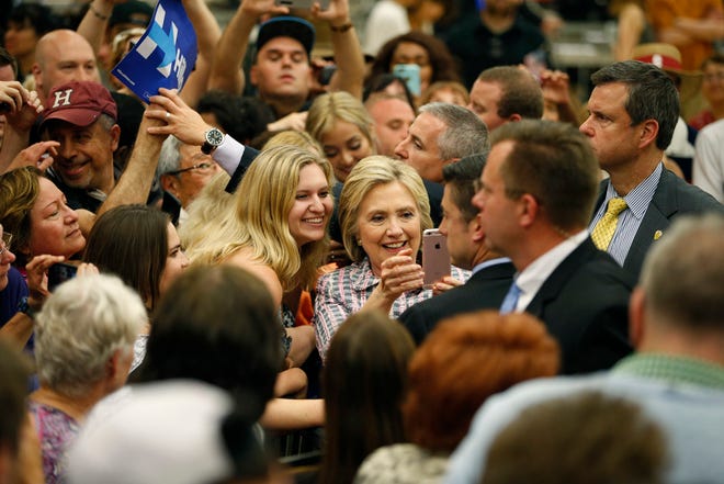 Democratic presidential candidate Hillary Clinton takes a selfie with supporters at a rally at Sacramento City College, Sunday, in Sacramento, Calif.