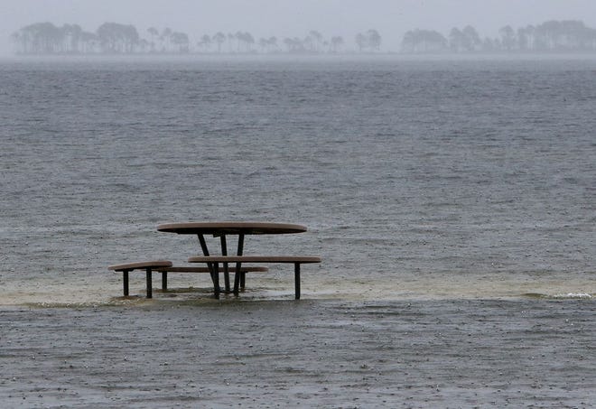 Rising water surrounds a picnic table near Tyndall Air Force Base on Monday.