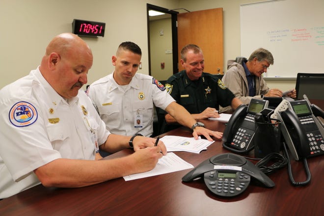 From left, Cristopher Croughwell, battalion chief of training for Lake County Fire Rescue; Jeffrey Hurst, fire lieutenant/EMT; Peyton Grinnell, chief deputy with the Lake County Sheriff’s Office; and Jim Stivender, head of the Lake County Public Works Department, were working at the Emergency Operations Center on Monday as Tropical Storm Colin threatened Florida.