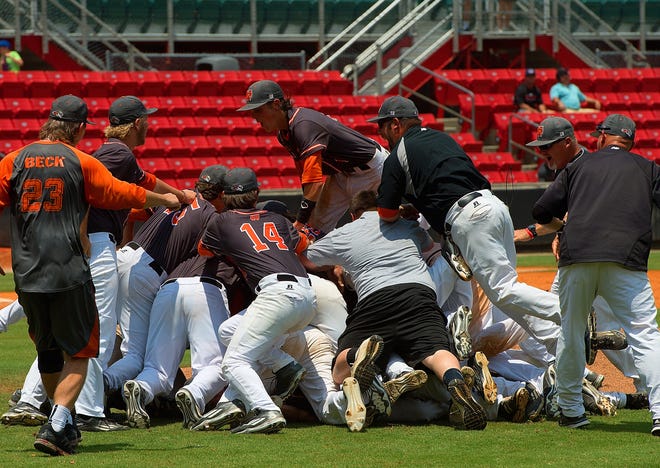 North Davidson players and coaches celebrate after winning the 4-A state championship over Green Hope at Five County Stadium in Zebulon on Saturday.