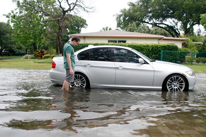 A driver's automobile stalls during high tide of Tropical Storm Colin in the Westshore area of Tampa.