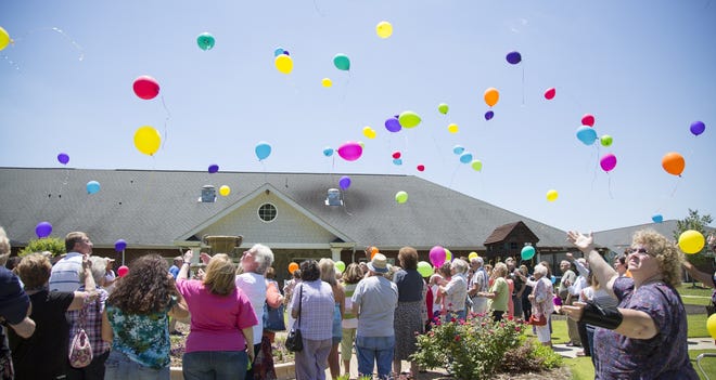 People release balloons during the annual memorial balloon release Wednesday at Hospice of Davidson County off U.S. Highway 64 East. Each year, Hospice of Davidson County invites members of the community to release environmentally friendly balloons for each patient who died in the last year. Sarah Louya/The Dispatch