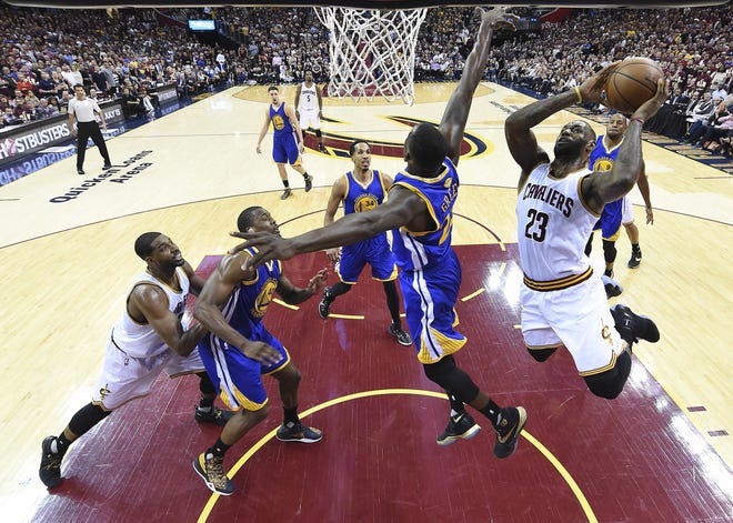 Cleveland Cavaliers forward LeBron James (23) drives to the basket against the Golden State Warriors during the first half of Game 3 of basketball's NBA Finals in Cleveland, Wednesday, June 8, 2016. (Bob Donnan/USA Today Sports via AP, Pool)