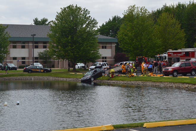 Emergency personnel pulled a man from a submerged car at Riley Street and Wellness Drive in Holland Township. Erin Dietzer/Sentinel Staff