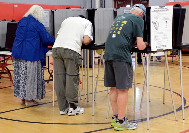 Voters fill out their ballots during the New Mexico primary election on Tuesday.