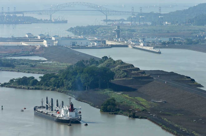 Tugboats guide a cargo ship to the Panama Canal's Miraflores locks near Panama City on May 26.
