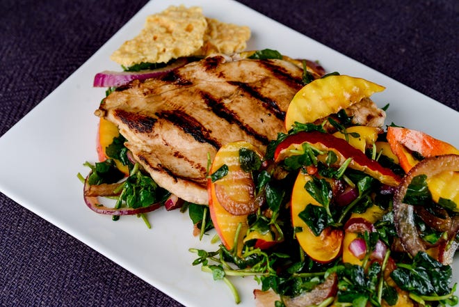 Balsamic chicken with watercress and nectarine salad; like the chicken, the salad gets the sweet-tangy balsamic vinaigrette treatment, which serves to mellow the greens, highlight the fruit and link the salad and poultry, flavorwise. (Washington Post)