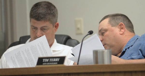 Greenwood Councilmen Lance Terry, left, and Tim Terry pore over paperwork during a monthly meeting Monday night, June 6, 2016, at City Hall. CHAD HUNTER/TIMES RECORD