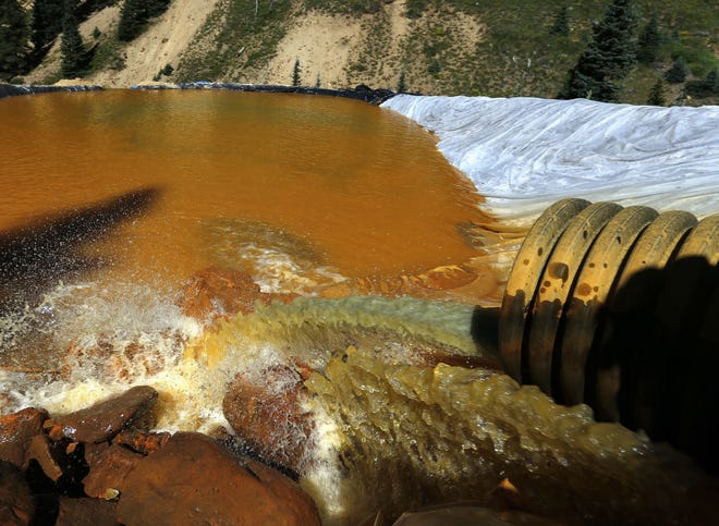 FILE - In this Aug. 14, 2015, file photo, water flows through a series of sediment retention ponds built to reduce heavy metal and chemical contaminants from the Gold King Mine wastewater accident, in the spillway downstream from the mine, outside Silverton, Colo. A proposal to deploy the powerful Superfund program to clean up inactive Colorado mines, including the Gold King Mine that unleashed millions of gallons of wastewater last year, isn’t stirring up much attention, despite formidable resistance in the past.