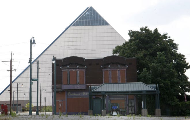 In this June 1, 2016 photo, vacant buildings stand near the Pyramid which houses a Bass Pro Shops megastore that opened in 2015, in Memphis, Tenn. Statistics describe an America that is nearly recovered from the Great Recession, but the national averages don't give a complete or accurate picture. Wealth is flowing disproportionately to the rich, skewing the data used to measure economic health. (AP Photo/Karen Pulfer Focht)