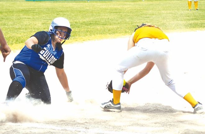 Inland Lakes junior Vanessa Wandrie (left) slides safely into third base during a Division 4 district championship contest against Pellston in Indian River last week. The Bulldogs will face Newberry in a regional semifinal in Newberry on Saturday at 10 a.m.