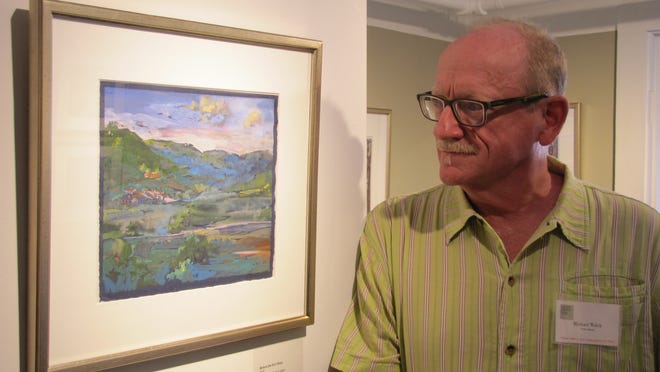 Artist Michael Walek looks at one of his paintings having in the "Atmosphere" exhibit at the George Marshall Store Gallery in York. Courtesy photo
