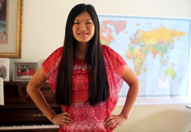 JoAnna Rudasill, 19, will graduate from Burns High School on Friday night. Rudasill has faced the challenges of polio, language barriers and coming to a new country after being adopted from China when she was 12 years old. Brittany Randolph/The Star