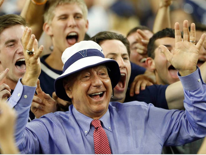 In this April 4, 2016, file photo, sportscaster Dick Vitale poses with Villanova fans before the NCAA Final Four tournament college basketball championship game between Villanova and North Carolina, in Houston. Vitale has agreed to a one-year contract extension that will keep him at ESPN through his 40th season with the network. ESPN announced on Vitale's 77th birthday Thursday, June 9, 2016, that the popular college basketball announcer's deal now goes through the 2018-19 season.