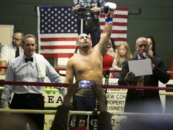 Ocala's Danny Santiago raises his left arm in victory after defeating Galen Brown in a fight in February at the Southeastern Livestock Pavilion. Santiago had a chance meeting with Muhammad Ali.