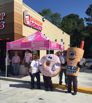 Mascots Sprinkles and Cuppy welcome guests to the grand opening of Dunkin’ Donuts’ newest Bay County location, 3706 W. U.S. 98 in Panama City.