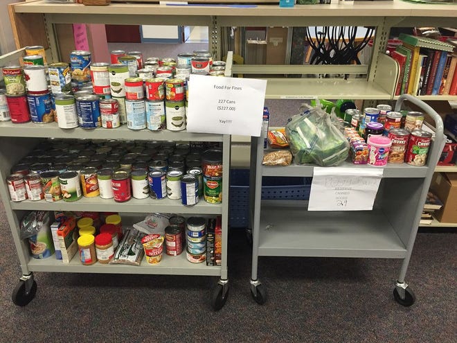 Cagan Crossings Community Library shows off its canned food donations as part of the Food for Fines program.