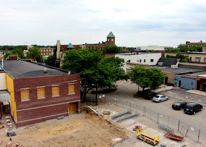 A view of the Eighth Street block from Pine to River in downtown Holland owned by Geenan DeKock Properties, looking to the northeast from Ninth Street June 4, 2016. The developer plans to keep the The Sentinel building (at left) and wants to construct new mixed-use buildings on either side of the newspaper -- all fronting Eighth. The block is within the new Satellite SmartZone. Jason Barczy/Sentinel Staff