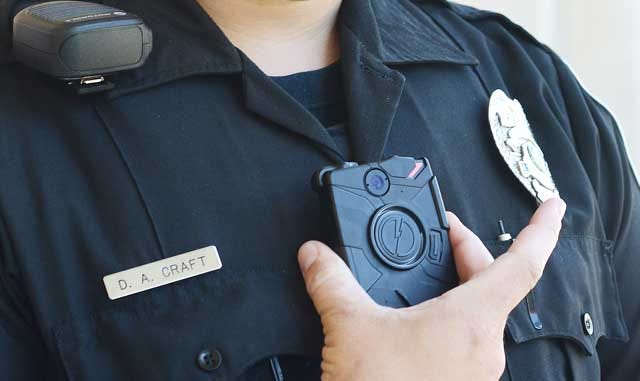 Officer D.A. Craft operates his body camera off South Queen Street at the Kinston Department of Public Safety.