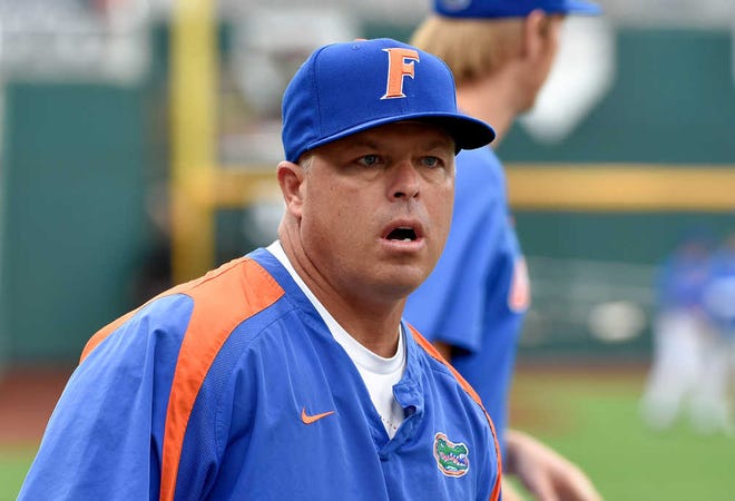 FILE - In this June 12, 2015, file photo, Florida coach Kevin O'Sullivan follows team practice at TD Ameritrade Park in Omaha, Neb. The Seminoles are just the next obstacle in Florida's road to redemption. (AP Photo/Mike Theiler, File)